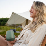 Woman smiling with wine tumbler in hand