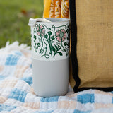 Anna Vaus 'Happy Trails' 16oz Tumbler on blanket at picnic - closeup of graphics
