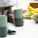 Pouring smoothie into tumbler