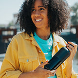 Woman holding a black water bottle