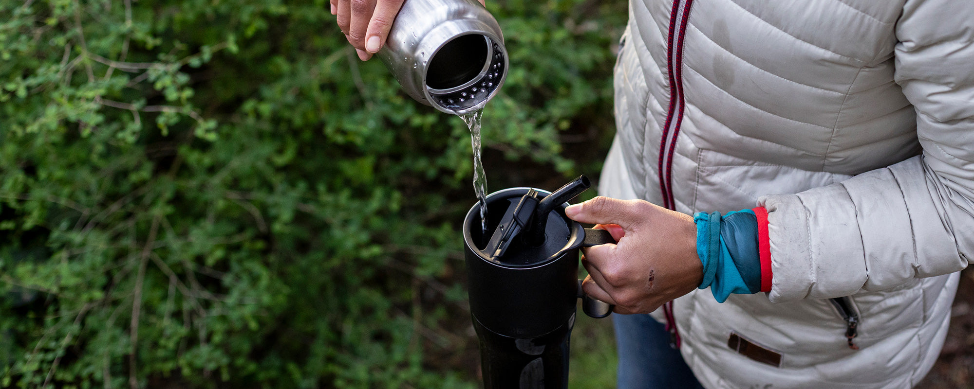 Person pouring water into tumbler