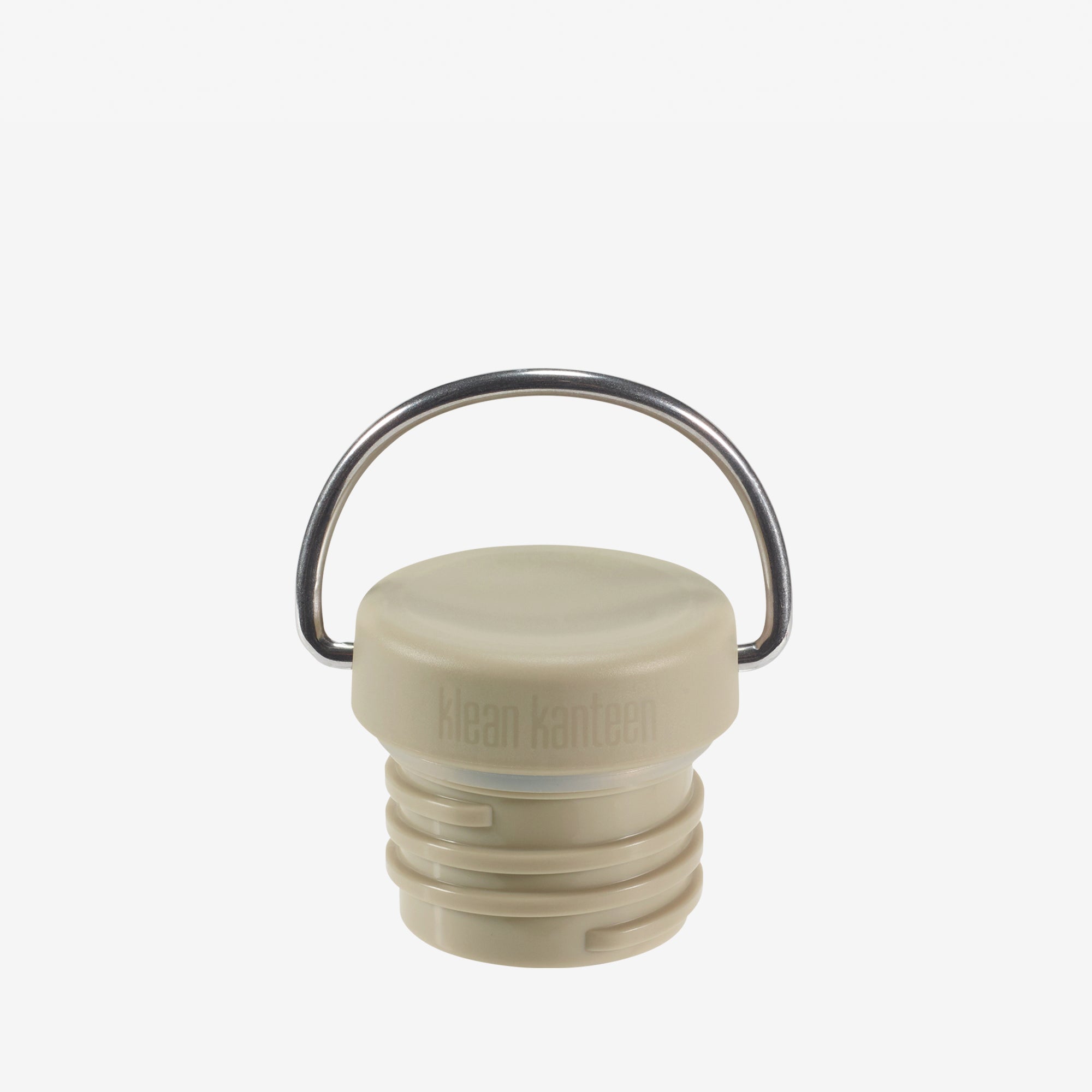Beige bottle cap with metal ring on a white background