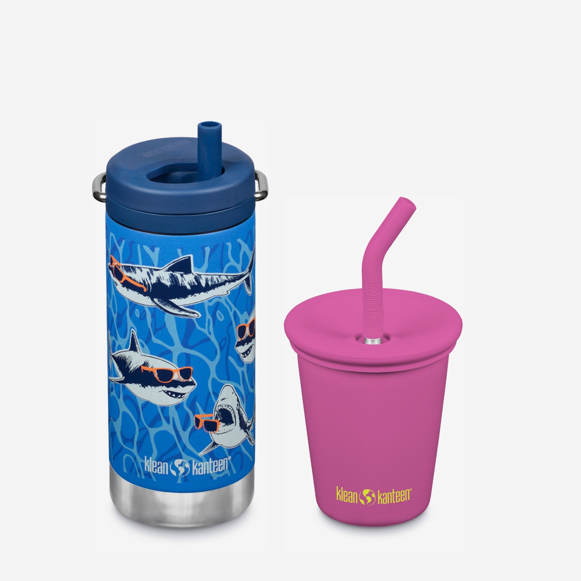 Blue tumbler with shark design and pink cup with straw on a white background