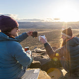 women toasting morning sunrise with camp coffee mugs