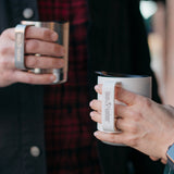 close up of Klean coffee mugs in hands