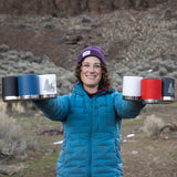 Woman with hands full of coffee mugs