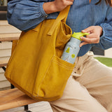 Woman pulling kid's bottle out of purse