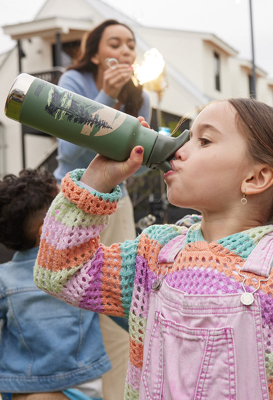 Girl drinking from kid's water bottle