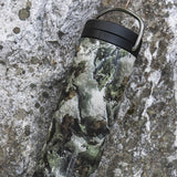 Camoflauge bottle against rock