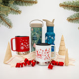 Holiday seasonal graphic tumblers and mugs and bottles on background