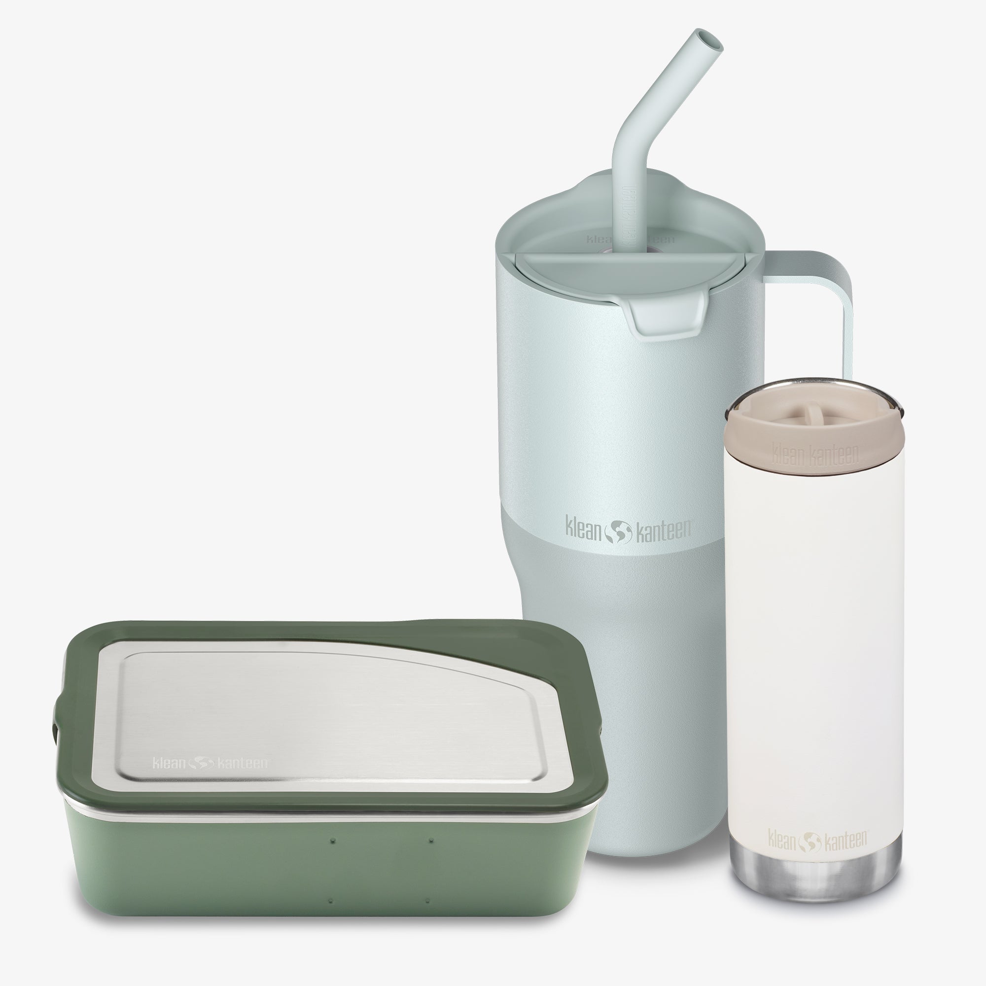 Set of reusable containers with a green food storage container, light blue tumbler with straw, and clear tumbler with beige lid on a white background.