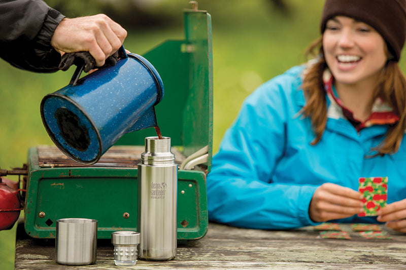 Pouring coffee into thermos while camping