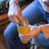 Person opening a yellow insulated tumbler twisting lid closed