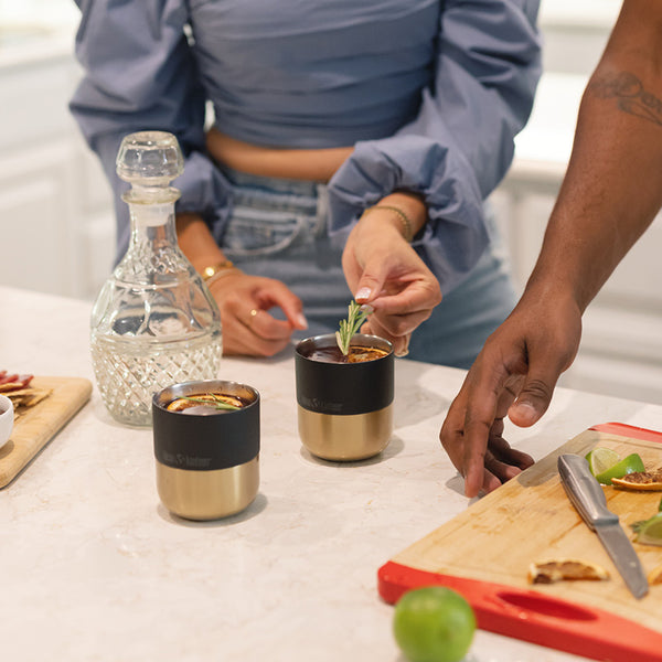 Cocktails in black and gold tumbler cup