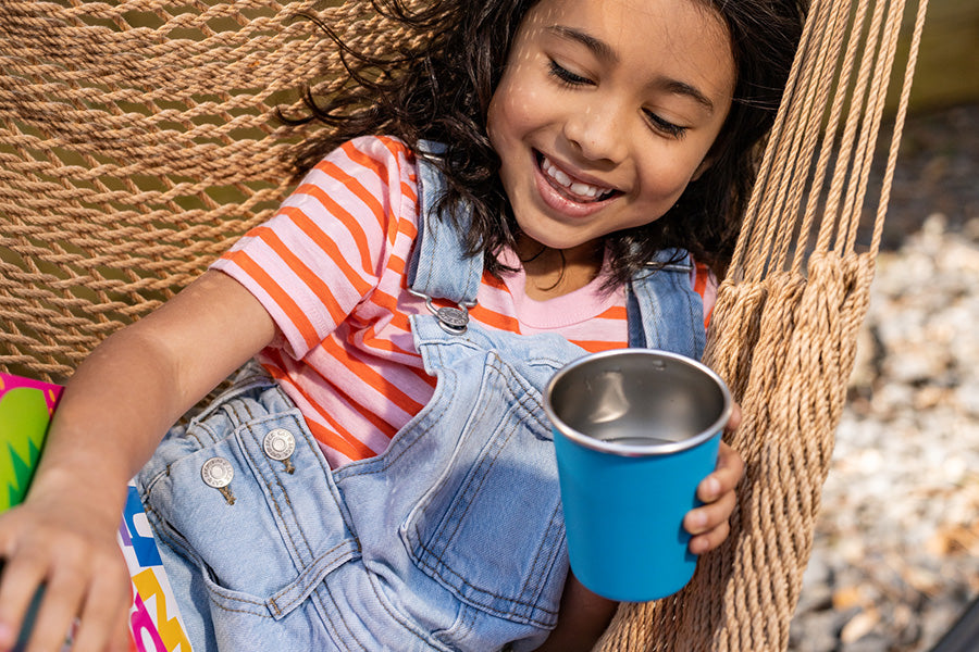 Girl in hammock with steel cup