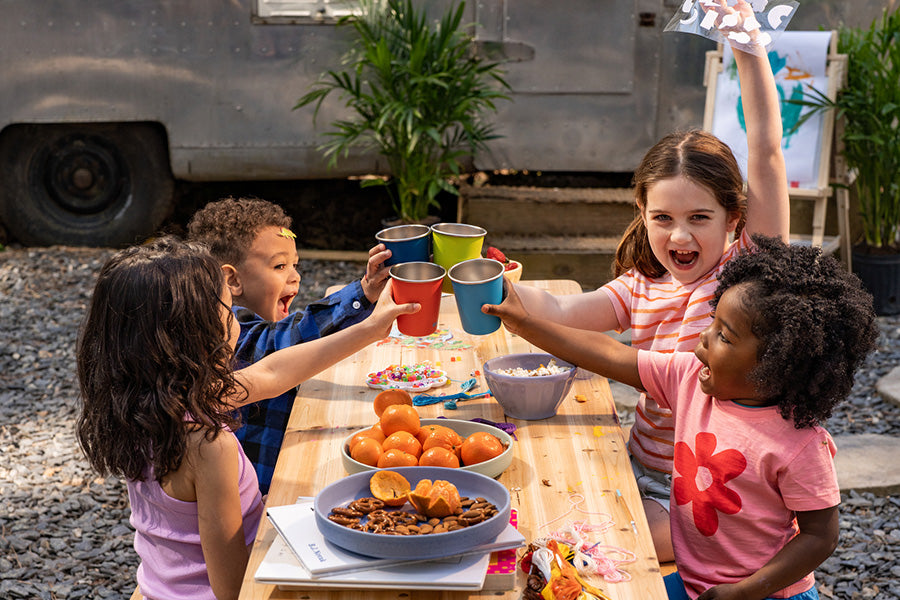 Kids at picnic table with cups