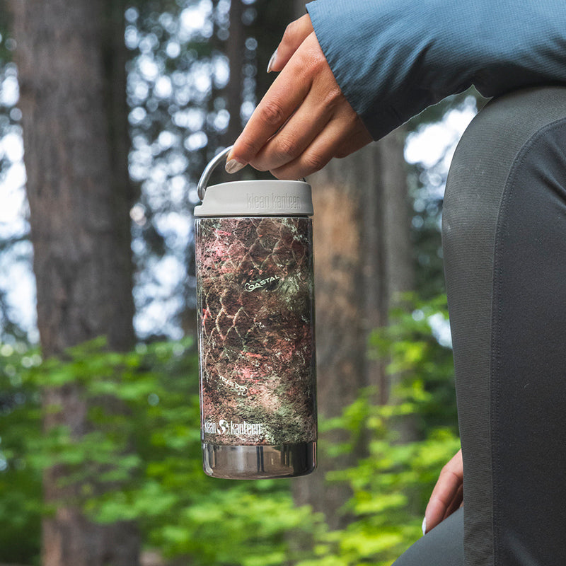 Hand holding camo water bottle