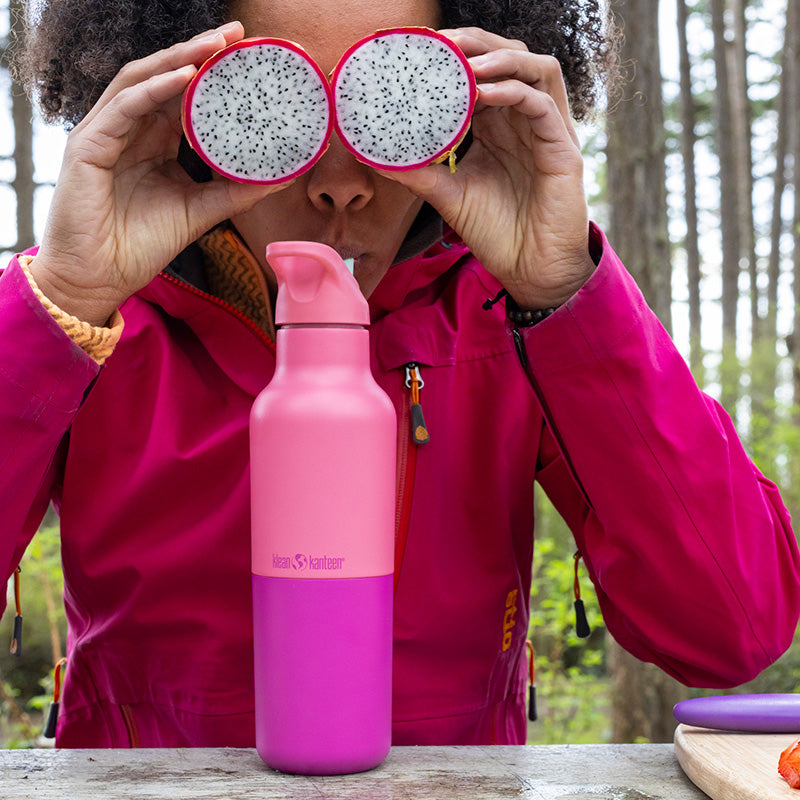 Pink water bottle with woman and fruit on eyes