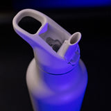 Close-up of a blue water bottle with a white cap on a black background