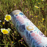 Tumbler with floral design in a field of wildflowers