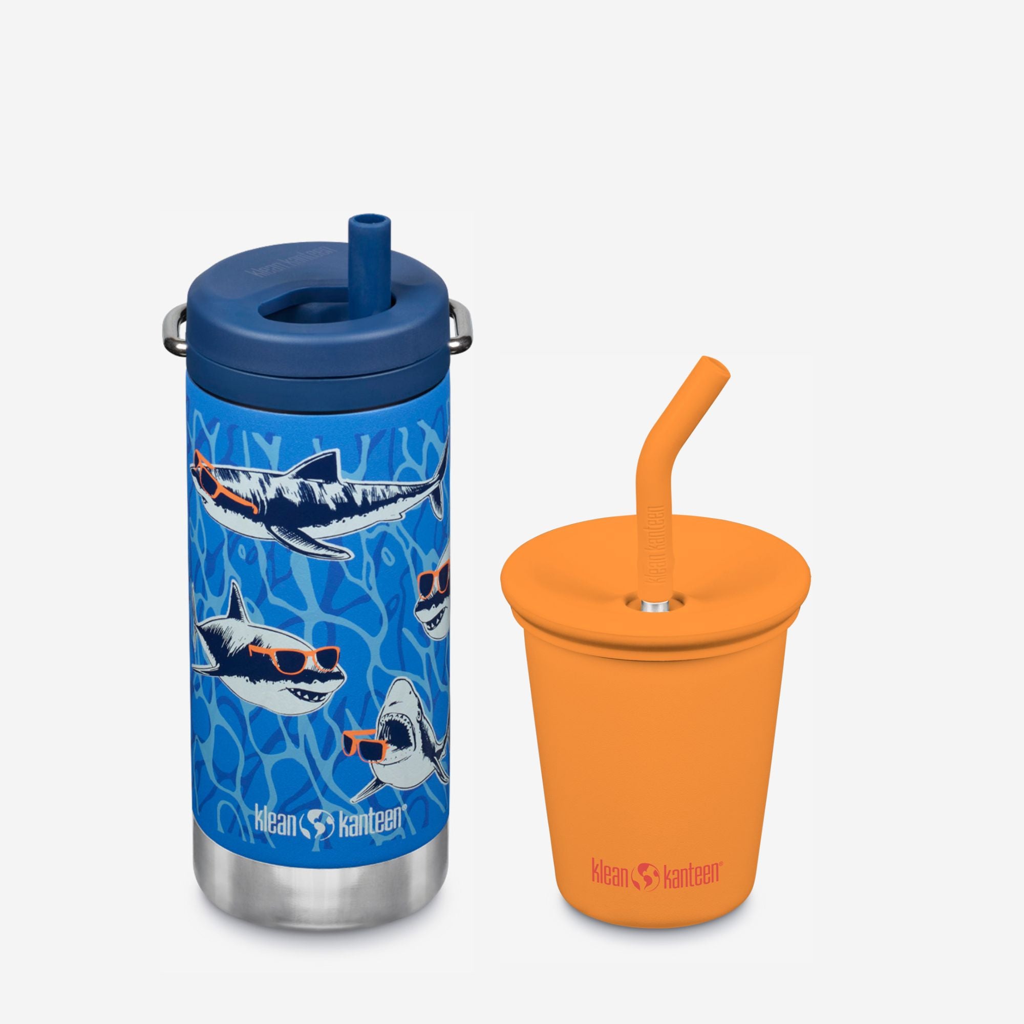 Blue tumbler with shark design and orange cup with straw on a white background