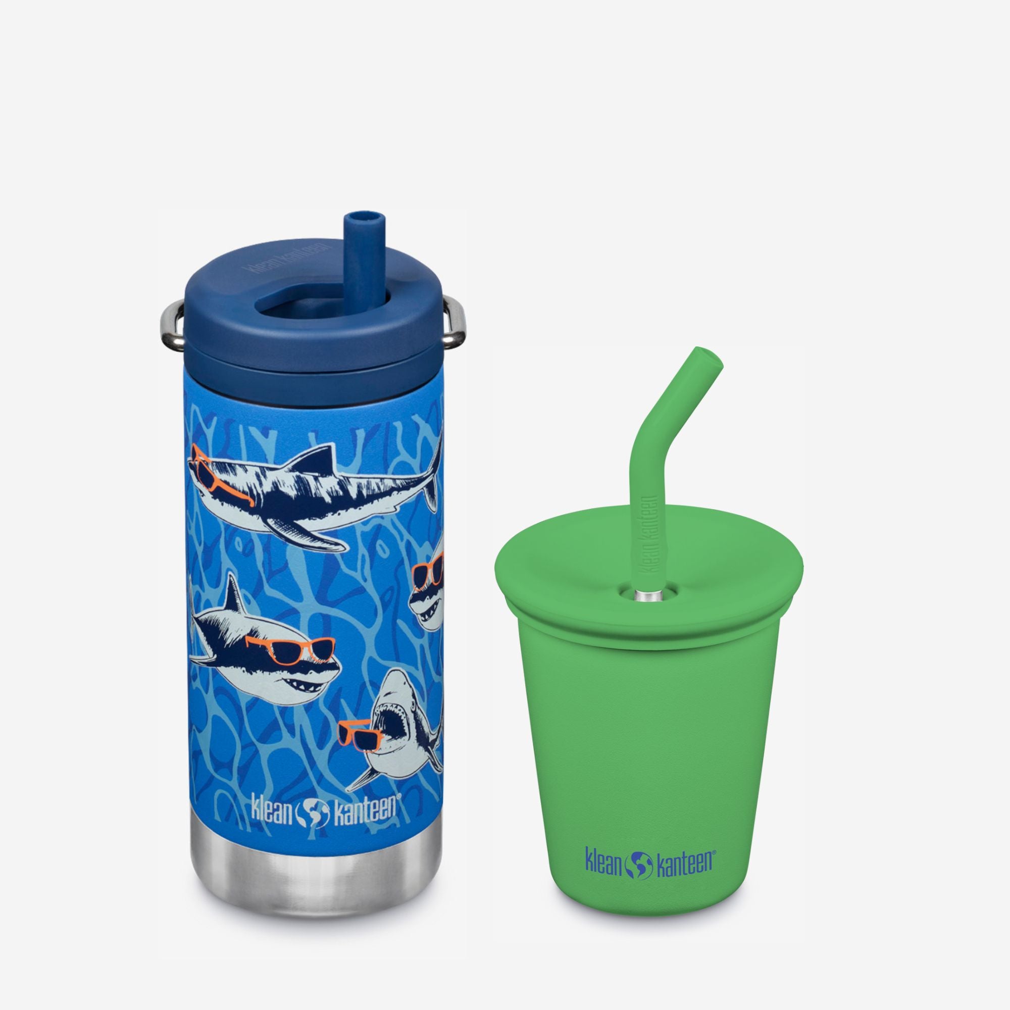 Blue tumbler with shark design and green sippy cup with straw on a white background