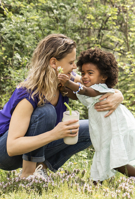 Mother and daughter in field with tumbler