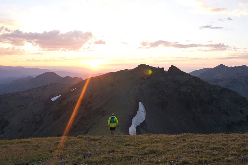 Guy trail running with water bottle