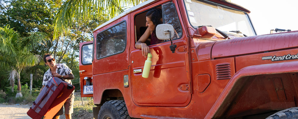 Woman in jeep with water bottle