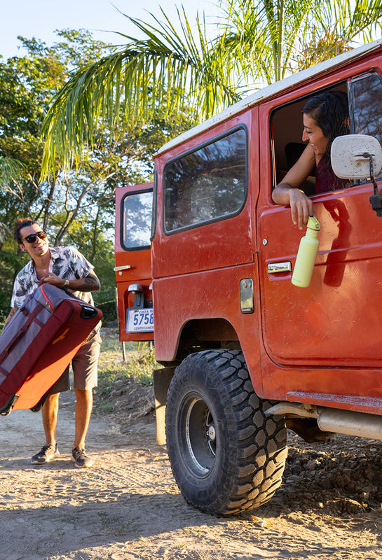 Woman in jeep with water bottle