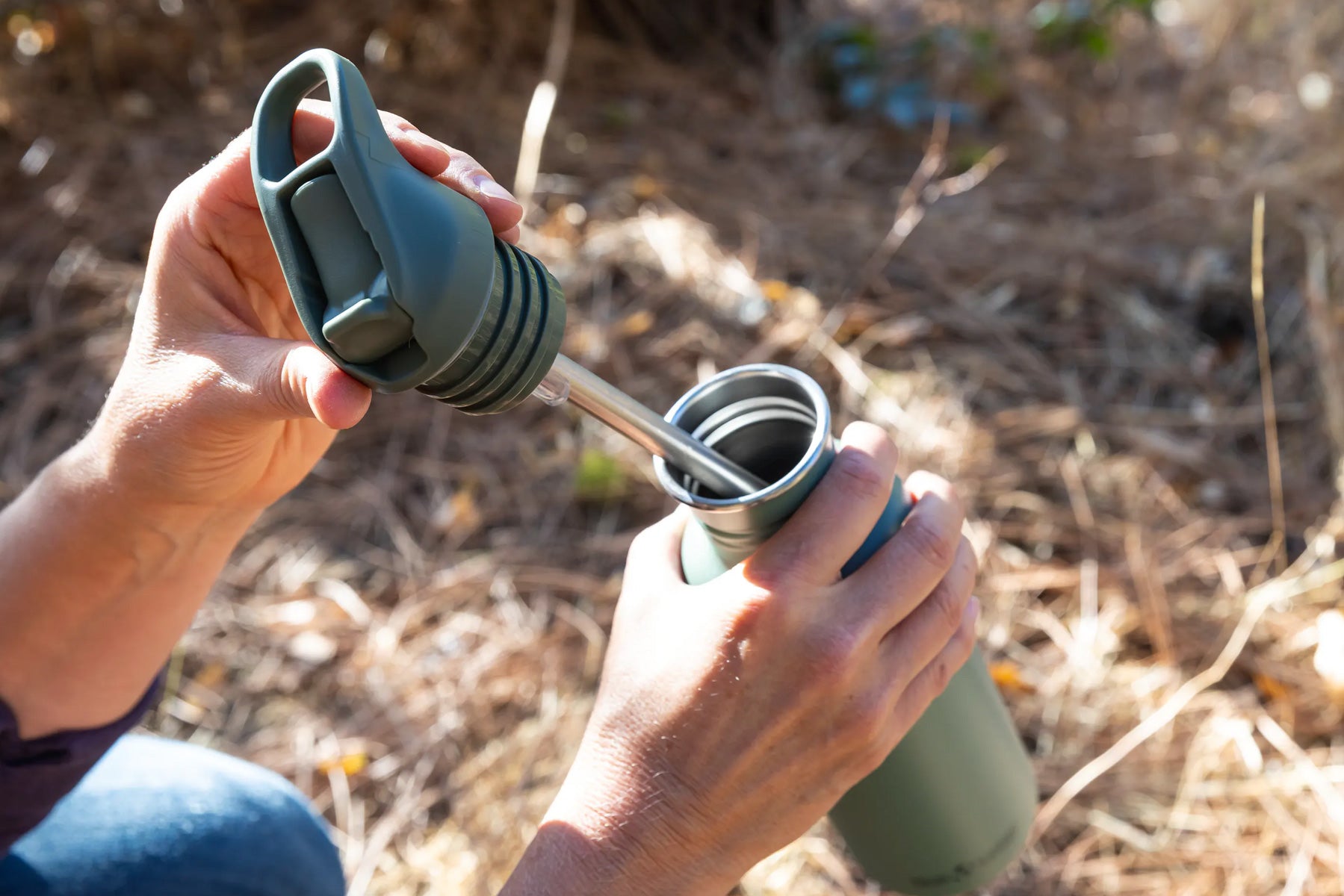 Pulling Flip Seal Sport Cap with straw out of water bottle