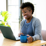 Working on laptop with coffee mug