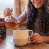 Pouring tea into coffee mug