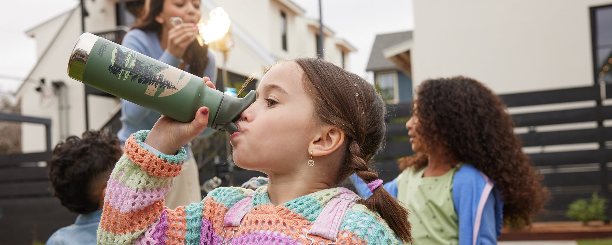 Girl drinking from kid's water bottle