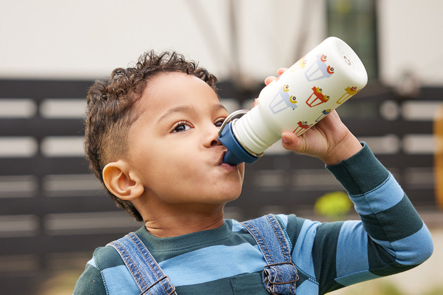 Boy drinking from Sippy bottle