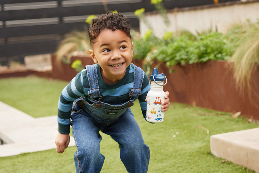 Boy smiling with Sippy bottle