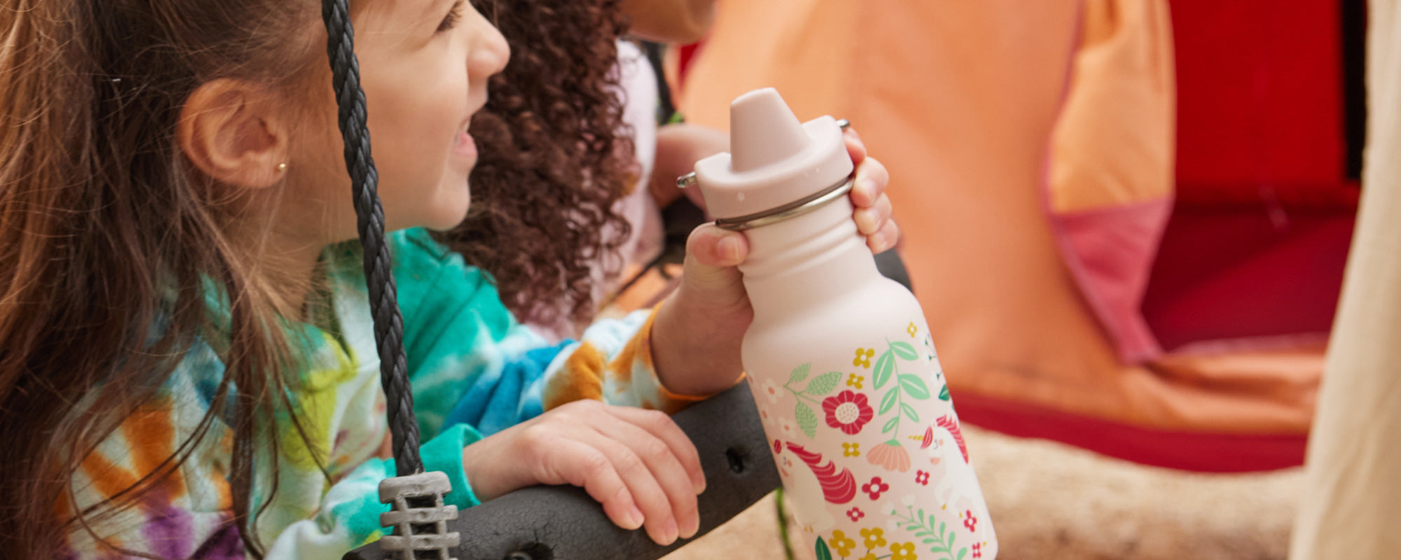 Girl with hand holding Sippy bottle