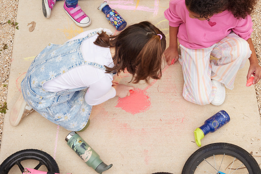 Kids on sidewalk with chalk and water bottles