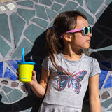 Girl with kids cup with straw lid