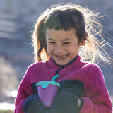 Girl smiling with kids cup and straw