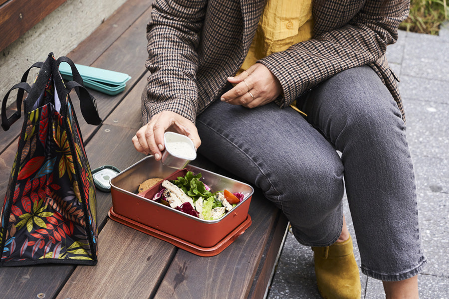 Lunch and meal in steel food box with sauce container