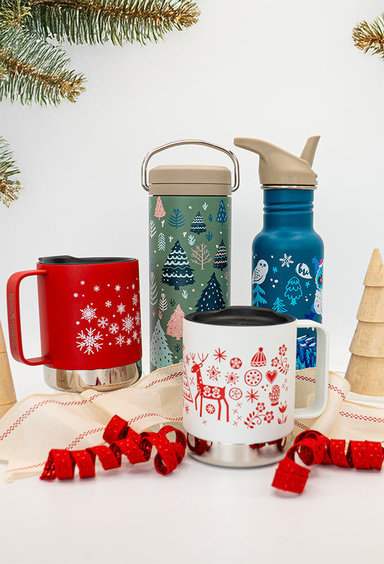 Set of Christmas-themed mugs and bottles with festive designs on a white background.