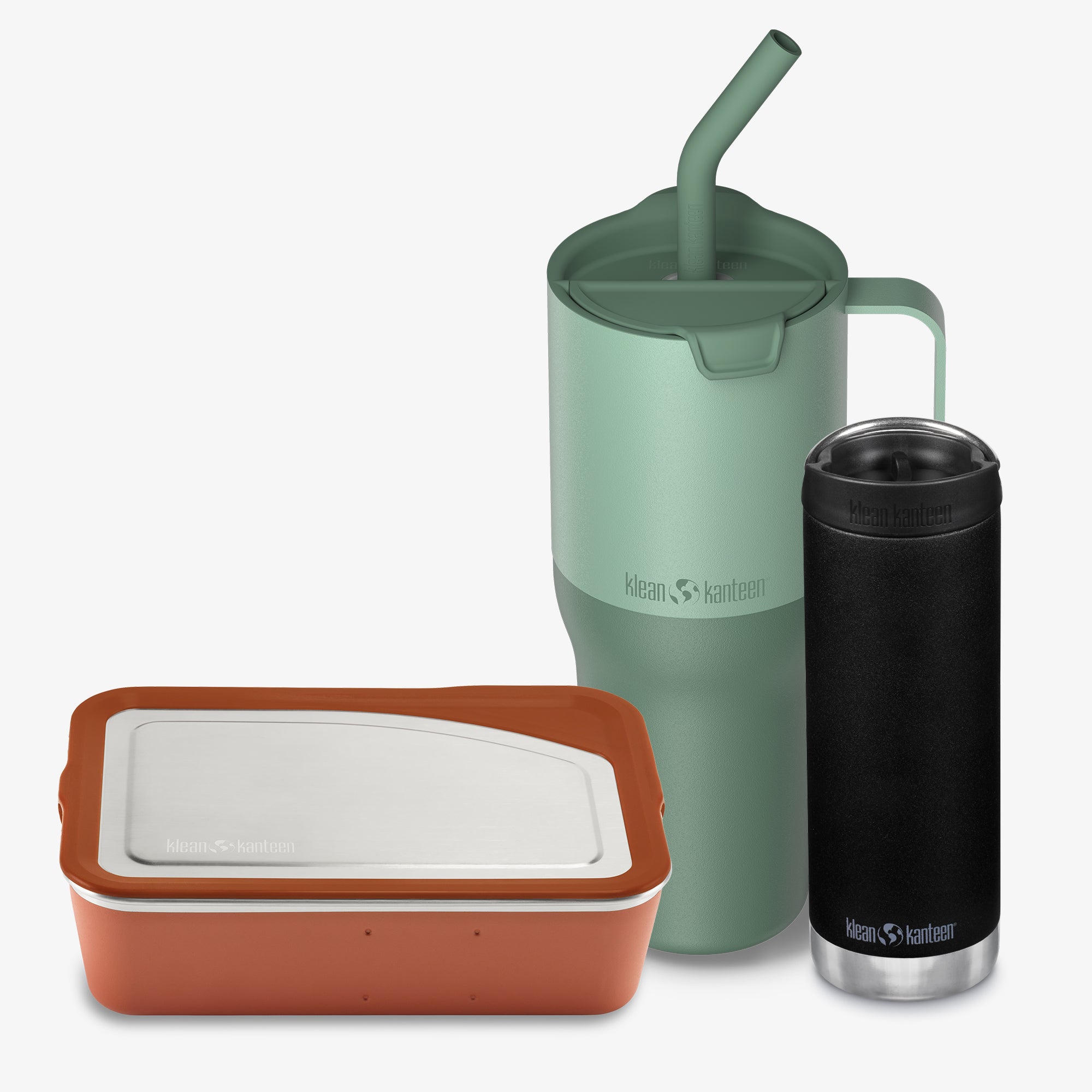 Three reusable containers with a green mug, black tumbler, and brown container on a white background.