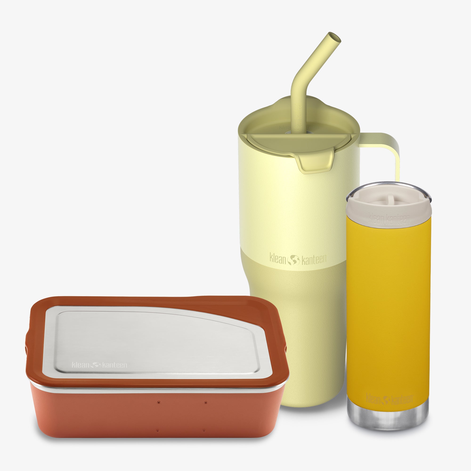 Yellow tumbler with straw, red container with white lid, and yellow glass with white liquid on a white background