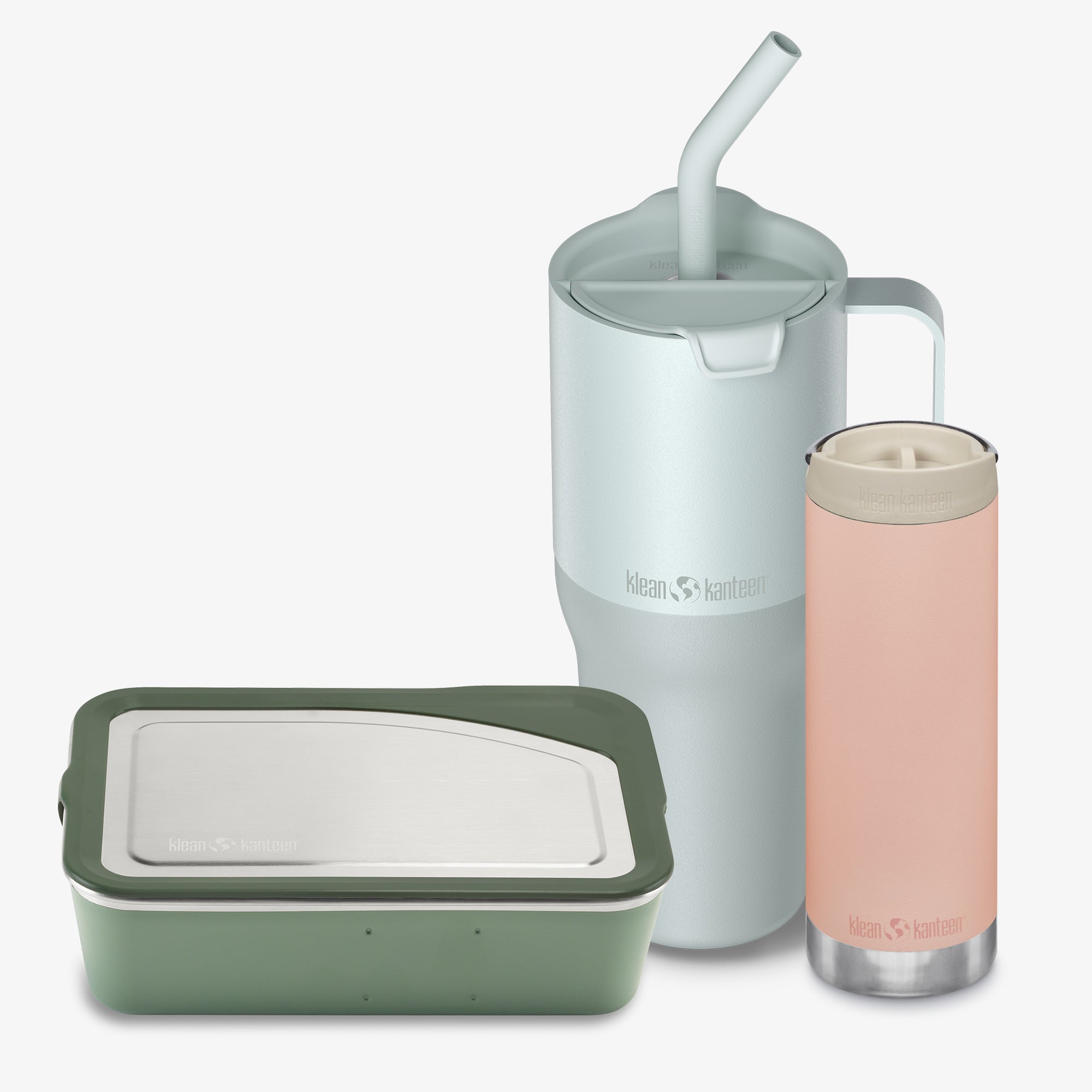 Set of reusable containers including a green food storage container, a silver mug with a straw, and a pink insulated bottle on a white background.