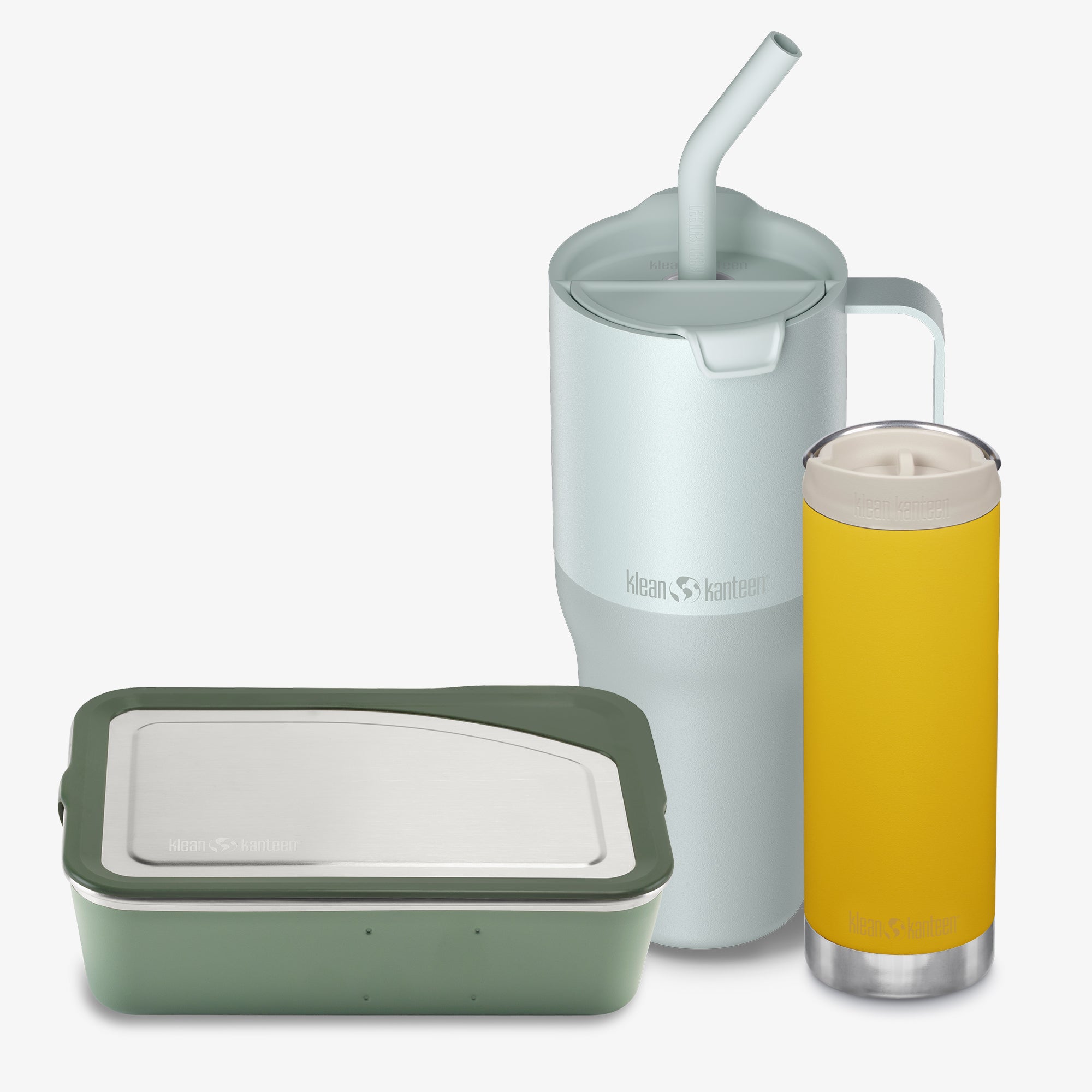 Set of reusable containers including a green food container, a white mug with a straw, and a yellow insulated cup on a white background.