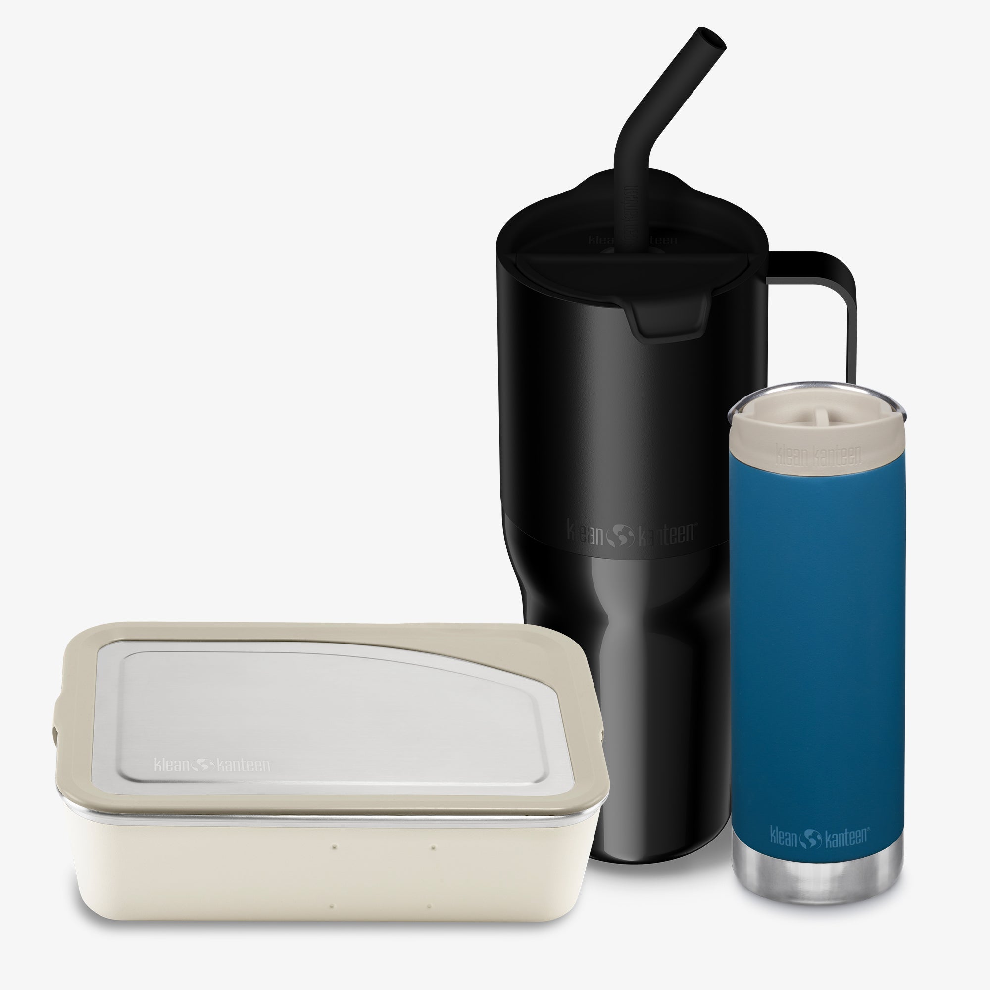Black insulated mug with straw, blue insulated tumbler, and beige food container on a white background