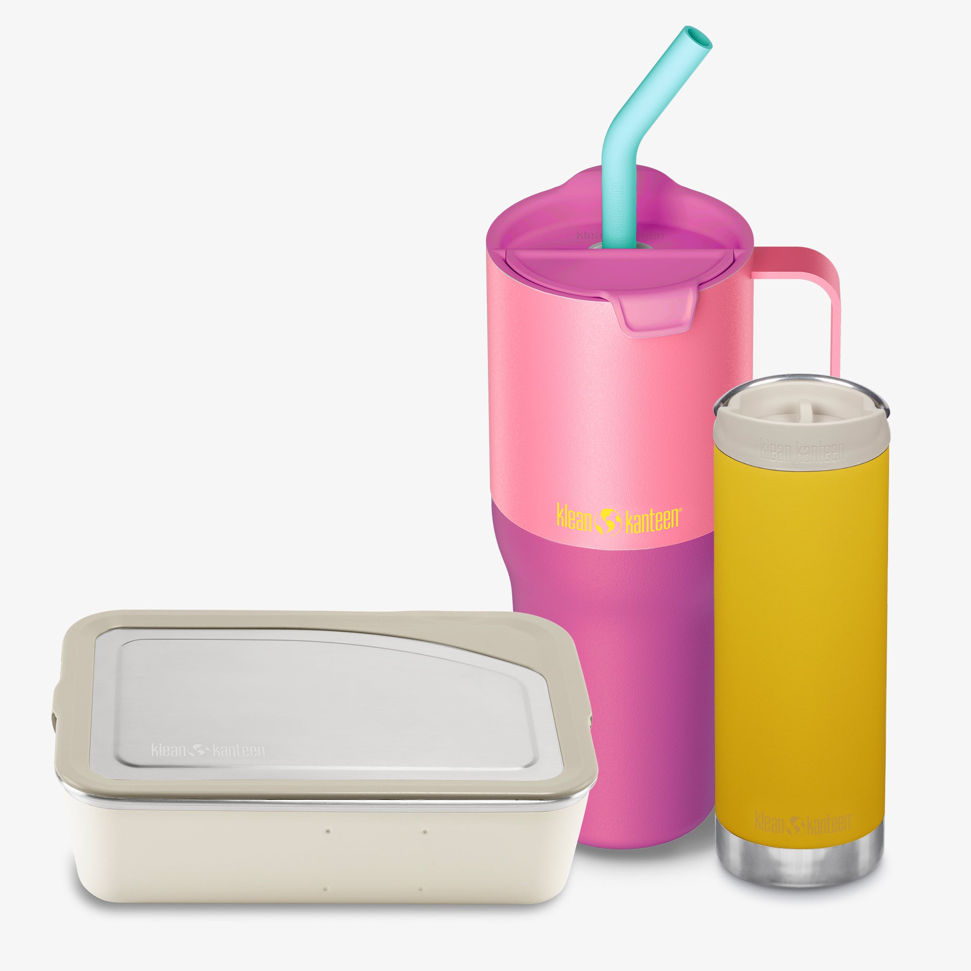 Pink tumbler with straw, beige container, and yellow glass with a drink on a white background
