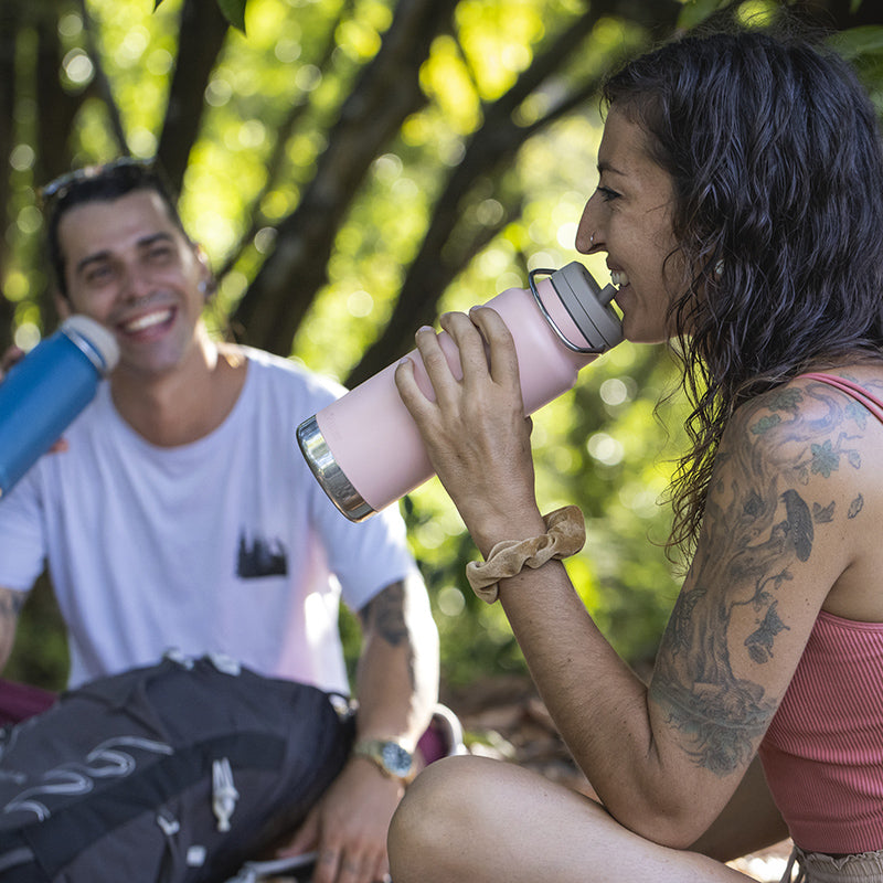 Couple laughing and smiling drinking water