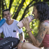 Couple laughing and smiling drinking water